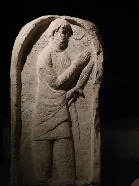 Eight-pointed cross inside a circle beside a man that appears to be praying to it